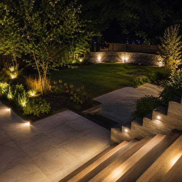 Pathway, garden, and stair lighting in a landscaped backyard